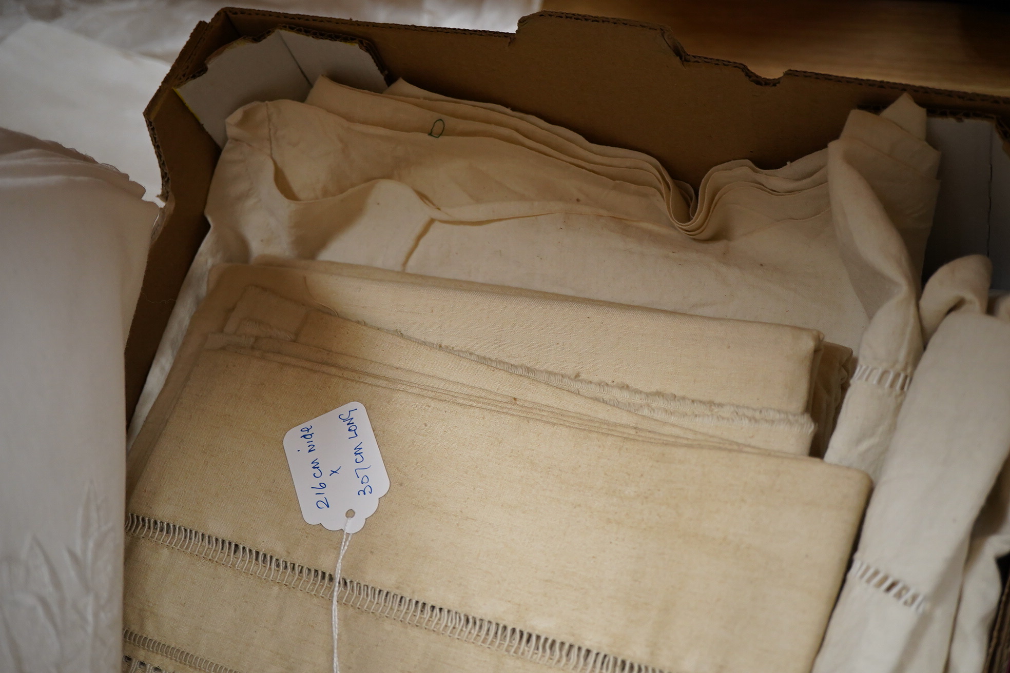 Four French provincial linen floral embroidered and drawn thread turn back, wide and long top sheets. Each sheet with different embroidery, dimensions and shades of linen, being ecru to off white. Condition - ecru sheet,